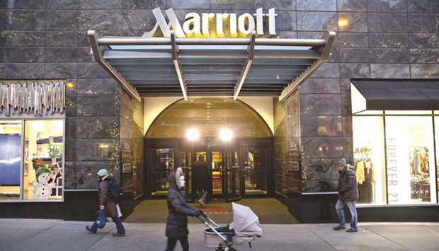 Pedestrians walk past a Marriott International hotel in Chicago. Marriottu2019s $13.6bn purchase of Starwood Hotel was a bet that its popular loyalty programme would bring more travellers to its Courtyards and Residence Inns. It turns out Marriott was also buying a massive security risk.