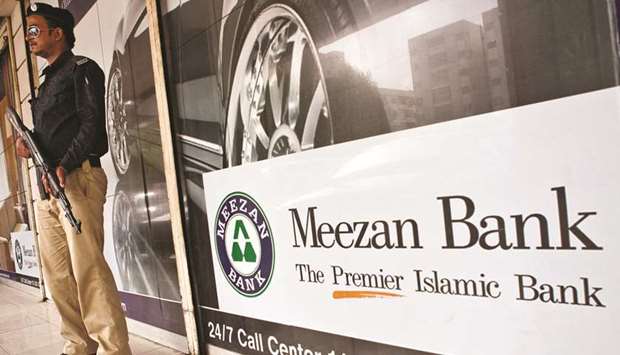 A security guard is standing on alert outside a Meezan Bank branch in Karachi in this file photo dated June 11, 2012. Asset quality indicators like non-performing finances (NPFs) to financing (gross) and net NPFs to net-financing of Islamic banking industry were recorded at 2.7% and 0.5%, respectively better than the overall banking averages.