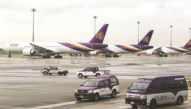 Vehicles drive past aircraft operated by Thai Airways International on the tarmac at Suvarnabhumi Airport in Bangkok (file). The Asia-Pacific region will be the source of more than half the new passengers over the next two decades.