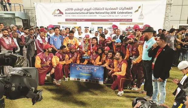 Qatar Cricket Association president Yousef Jeham al-Kuwari, QCA Operations manager Manzoor Ahmad and Domestic Cricket head Gul Khan Jadoon pose with the Qatar Stars players after their victory over Asian Stars in the Twenty20 match, which was held as part of the Qatar National Day celebrations at the Asian Town Cricket Stadium in Doha on Tuesday.