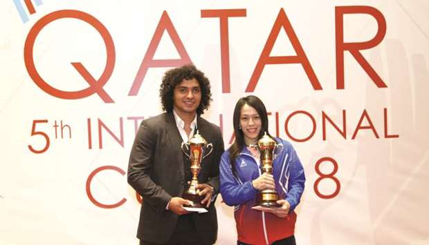 Qataru2019s Fares Ibrahim Hassouna and Taipeiu2019s Kuo Hsing-Chun pose with their trophies after topping the menu2019s and womenu2019s points charts in the 5th International Qatar Cup Weightlifting Championships in Doha.