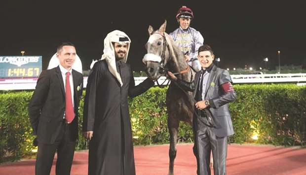 HE Sheikh Joaan bin Hamad al-Thani (second from left) with Amir Al Cham, who was ridden to victory by Julien Auge (second from right) in the Qatar Derby (Group 3 PA), at the Al Rayyan Park yesterday. Thomas Fourcy (left) is the trainer of the gelding.