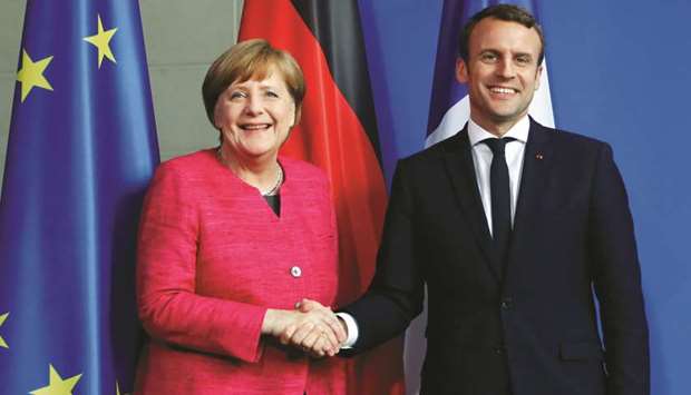 File picture of Angela Merkel and French President Emmanuel Macron shaking hands after a news conference at the Chancellery in Berlin, Germany, on May 15, 2017.