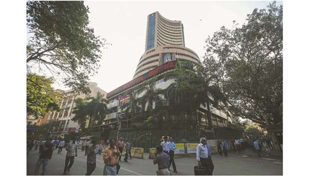 People walk by the Bombay Stock Exchange building in Mumbai (file). The Sensex closed up 0.5% to 41,558.57 points yesterday.