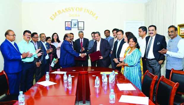 ICBF president P N Baburajan and Damaan Islamic Insurance Company chief operating officer G Harikrishnan handing over the MoU in the presence of Indian ambassador P Kumaran as community leaders look on