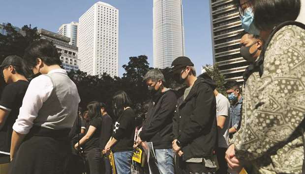 Anti-government demonstrators stand still during a moment of silence at Chater Garden in Hong Kong.