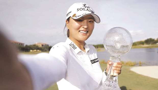 Ko Jin-young of Korea imitates a u201cselfieu201d as she poses with the CME Globe trophy after winning the CME Group Tour Championship in Naples, Florida.