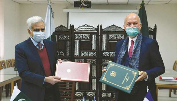 Ministry of Economic Affairs Secretary Noor Ahmed and Yves Manville, deputy head of mission of the French embassy, exchange agreement copies of the G20 Debt Service Suspension Initiative (DSSI), in Islamabad.