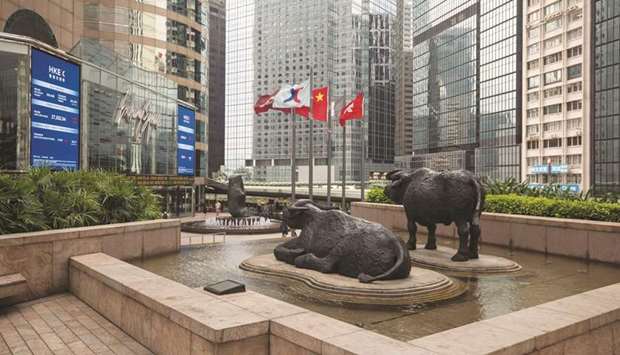 Sculptures stand outside the Hong Kong Stock Exchange. The Hang Seng closed up 0.9% to 26,343.10 points yesterday.