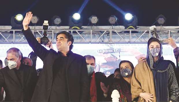 PPP Chairman Bilawal Bhutto-Zardari waving to party supporters at the annual homage to his mother and late prime minister Benazir Bhutto in Larkana yesterday. Also seen in a face mask on the right is PML-N vice-president Maryam Nawaz, daughter of former prime minister Nawaz Sharif.