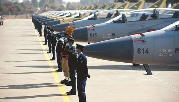 Pakistani Air Force personnel stand guard in front of the JF-17B multi-role aircraft rolled out at the ceremony. (AFP)