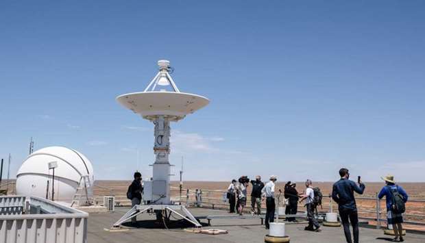 Members of the media alongside representatives of The Japan Aerospace Exploration Agency (JAXA) tour the roof of the Royal Australian Air Force's (RAAF) Woomera Range Complex in Woomera in South Australia on ahead of JAXA's Hayabusa 2 probe's expected sample drop to earth after landing on and gathering material from an asteroid some 300 million kilometres from Earth