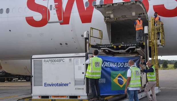 A container carrying doses of the CoronaVac vaccine is unloaded from a cargo plane that arrived from China at Guarulhos International Airport in Guarulhos, near Sao Paulo, Brazil, on December 3