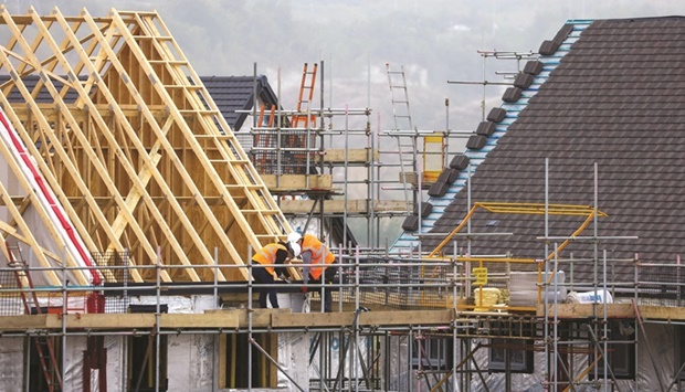 Labourers work on the roofing section of a new home at a residential construction site in Ebbsfleet, UK. Britainu2019s economy barely grew in October, even before the emergence of the Omicron coronavirus variant, further denting expectations that the Bank of England will raise interest rates next week for the first time since the pandemic struck.