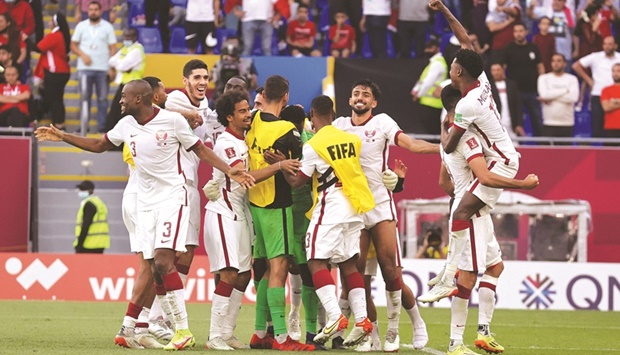 Qatar players celebrate after winning their third-place playoff against Egypt during the FIFA Arab Cup at the Stadium 974 in Ras Abu Aboud on Saturday. (Reuters)