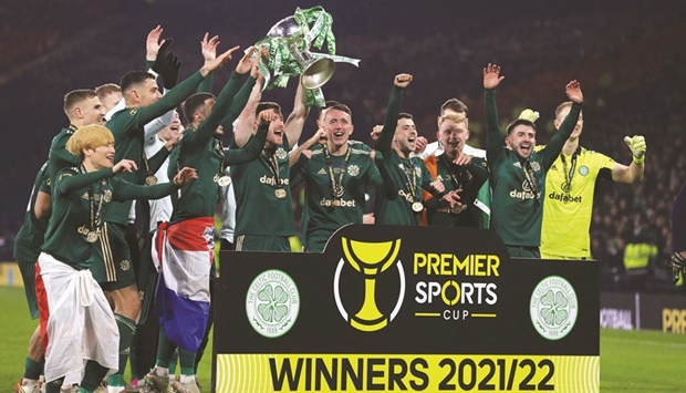 Celtic players celebrate with the trophy after winning the League Cup final in Glasgow, Scotland, yesterday. (Reuters)