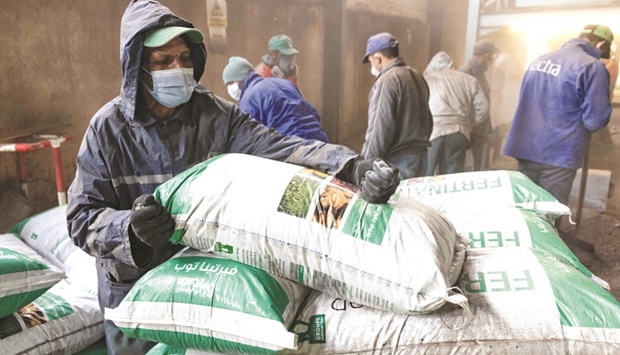 Workers fill bags with fertiliser in the Elephant Vert factory in the u2018Agropolisu2019 industrial zone in Moroccou2019s northern city of Meknes. Recycling in Morocco may be in its infancy, but the North African kingdom is making steady progress, helped by a Swiss firm that specialises in processing organic waste.