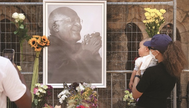 People offer flowers at St Georges Cathedral, where a Wall of Remembrance for Tutu has been set up. (Reuters, AFP)