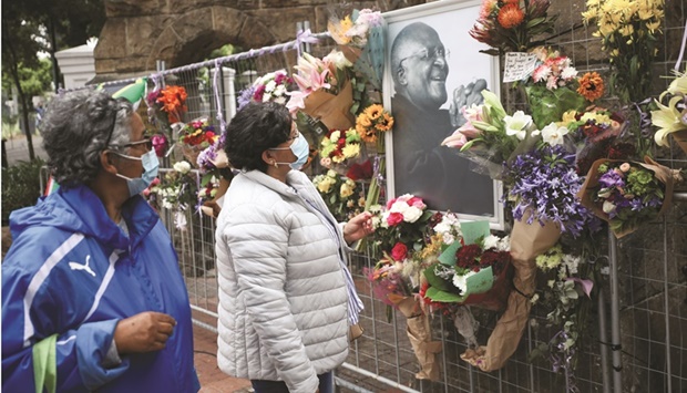 Mourners (left) pay their respects outside St Georgeu2019s Cathedral in Cape Town.