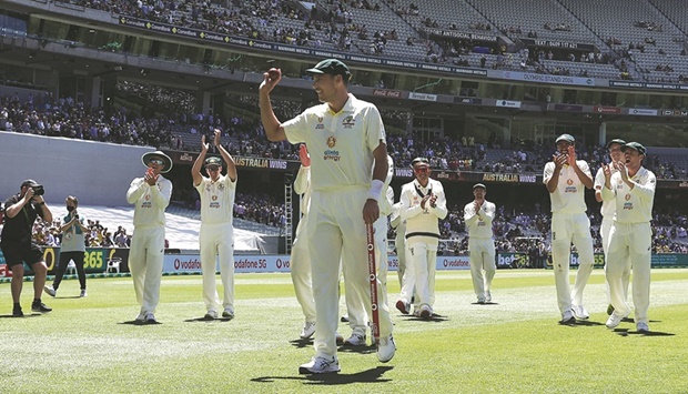 Scott Boland celebrates with teammates after Australia won the third Test in Melbourne yesterday to retain the Ashes. (Reuters)