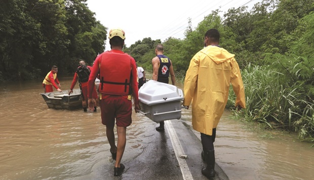 This picture released by the Bahia state government shows rescuers and firefighters taking empty coffins in boats and jet-skis from Ilheus to the Costa do Cacau Regional Hospital in Itabuna, during floods caused by heavy rains in the region.