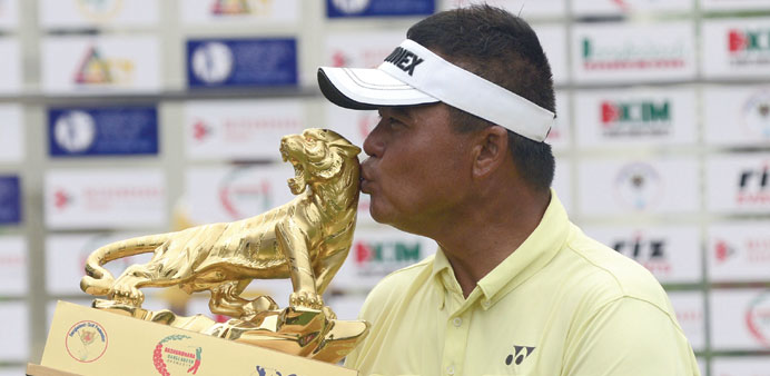 Mardan Mamat of Singapore kisses the trophy after winning the Bashundhara Bangladesh Golf Open at the Kurmitola Golf Club in Dhaka yesterday.