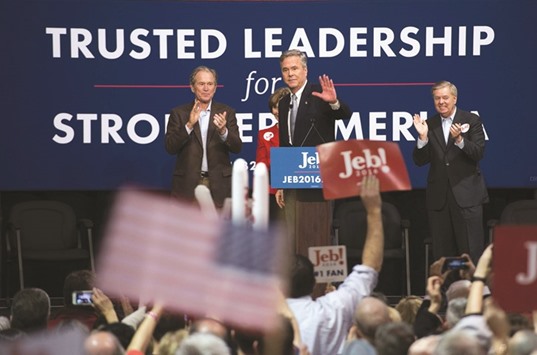 Republican presidential candidate Jeb Bush waves to supporters as he stands on stage with former president George W Bush (left) and Senator Lindsey Graham during a campaign rally in Charleston on Monday.