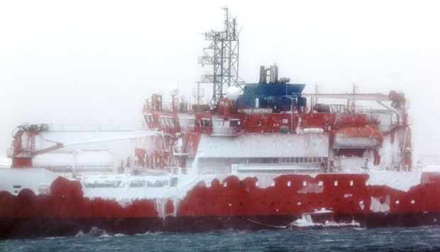 Ice can be seen forming on the icebreaker Aurora Australis, as viewed from the Australian Research Station of Mawson in Antarctica.