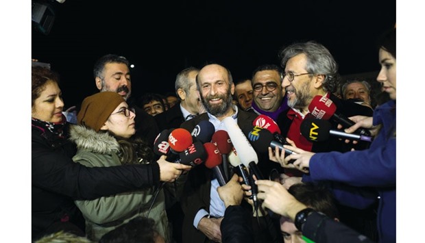 Can Dundar (right), Cumhuriyetu2019s editor-in-chief and Erdem Gul (left), Cumhuriyetu2019s Ankara bureau chief, speak to the media after being freed from Silivri prison in Istanbul early yesterday.