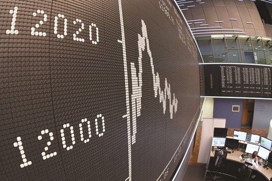 A board displays the chart of Germanyu2019s share index DAX that exceeded the mark of 12,000 points yesterday.