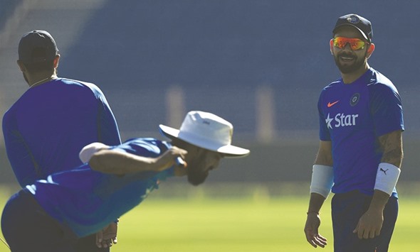 India captain Virat Kohli (right) smiles during a training session at the Maharashtra Cricket Association stadium in Pune yesterday. (AFP)