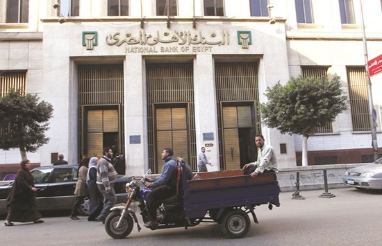 An exterior view of the National Bank of Egypt in Cairo. The central bank has said commercial lenders attracted $9bn since the float, largely from households and private businesses selling foreign currency and remittances from abroad.