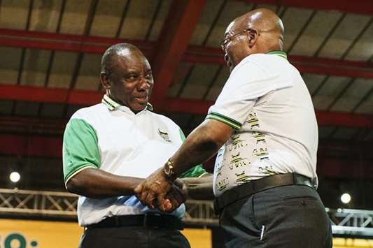 Cyril Ramaphosa (left), South Africau2019s deputy president and newly elected president of the African National Congress party (ANC), shakes hands with South African President Jacob Zuma on stage during the 54th national conference of the African National Congress party in Johannesburg on December 18, 2017. Zuma announced his departure late on Wednesday in a national broadcast just hours before the ruling African National Congress was scheduled to vote on a motion of no confidence in him in parliament.