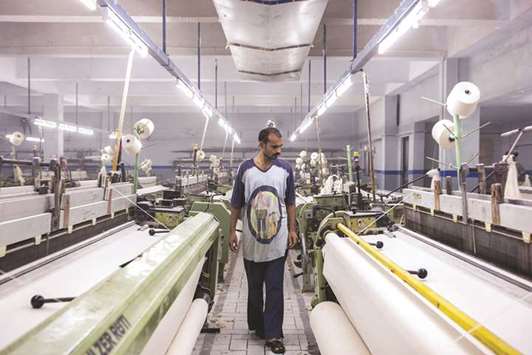 An employee is seen at a garment factory in Karachi. Pakistanu2019s exports started to pick up in the range of 10% to 11% in the first seven months of the current fiscal year. However, the overall performance of exports remained dismally low and stood at $20.4bn in the last fiscal year of 2016/17.