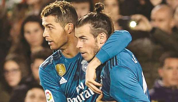 Real Madridu2019s Cristiano Ronaldo (left) celebrates with teammate Gareth Bale after scoring a goal against Real Betis last week. (AFP)