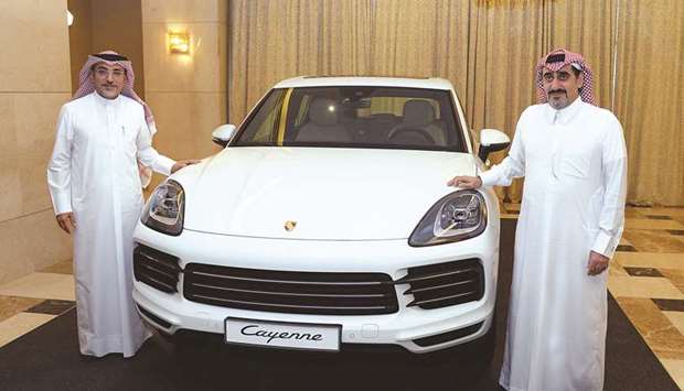 Salman Jassem al-Darwish (right) and Ahed Dawood unveil the new Cayenne yesterday. PICTURES: Thajudheen