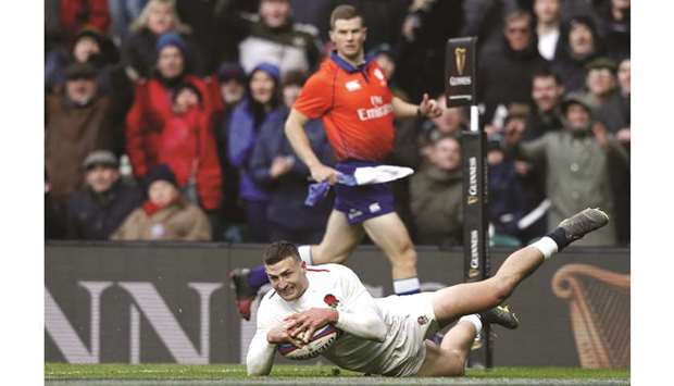 Englandu2019s wing Jonny May dives over the line to score his third try during his teamu2019s Six Nations international rugby union match against France at Twickenham stadium in south-west London yesterday.