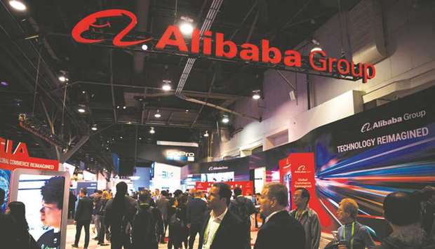 Attendees walk past the Alibaba Group Holding booth at the 2019 Consumer Electronics Show in Las Vegas. The e-commerce giant bought 117.1mn Hong Kong-listed shares of China International Capital Corp at HK$15.50 apiece, CICC said in a filing.