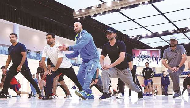 QU president Dr Hassan al-Derham and other officials participate in the National Sport Day activities yesterday.