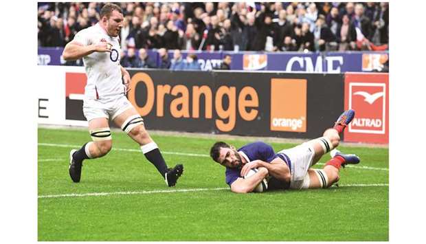 Franceu2019s flanker Charles Ollivon (right) dives across the line to score a try during the Six Nations match against England at the stade de France in Paris yesterday. (AFP)