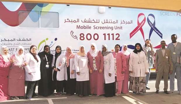 Officials and staff from PHCC and HMC in front of the mobile screening unit.