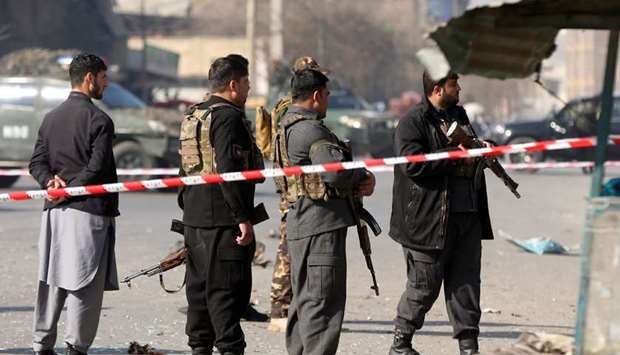 Afghan police officers stand guard at the site of an explosion in Kabul