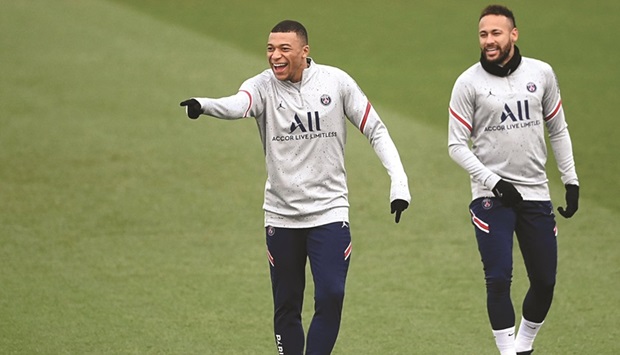 Paris Saint-Germainu2019s Kylian Mbappe (left) and Neymar share a light moment during a training session in Saint-Germain-en-Laye, west of Paris, yesterday. (AFP)