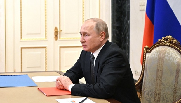 Russian President Vladimir Putin chairs a meeting with members of the Security Council via teleconference call at the Novo-Ogaryovo state residence outside Moscow, on February 18,  2022.