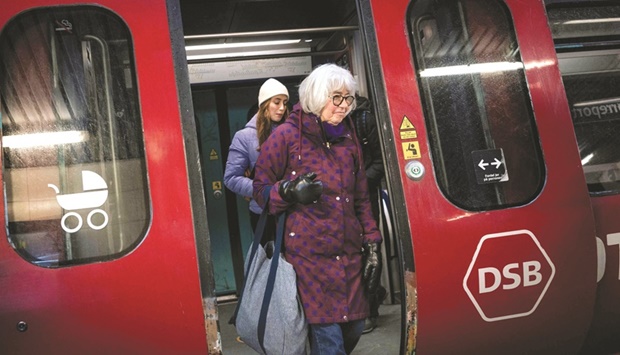 Unmasked commuters at the Noerreport metro station in Danish capital Copenhagen yesterday. (AFP)