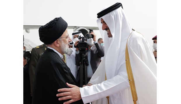 His Highness the Amir Sheikh Tamim bin Hamad Al-Thani receives the President of the Islamic Republic of Iran Ebrahim Raisi upon his arrival at Doha International Airport