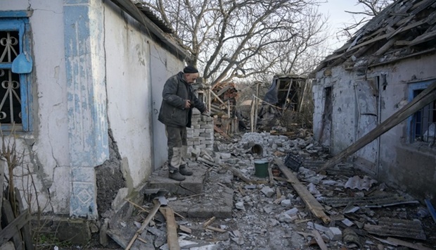 Local resident Valeriy, 63, shows a building, which he said was damaged by recent shelling in the village of Taramchuk in the Donetsk region, Ukraine. REUTERS