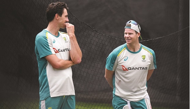 Australia captain Pat Cummins (left) speaks with teammate Steve Smith during their final practice session at the Melbourne Cricket Ground in Melbourne yesterday, before their departure for the teamu2019s first tour of Pakistan since 1998. (AFP)