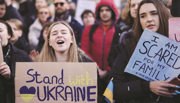 Demonstrators hold placards at a protest rally in central London yesterday. The UK government has ordered all assets of President Vladimir Putin and his Foreign Minister Sergei Lavrov frozen over Russiau2019s invasion of Ukraine. (AFP)