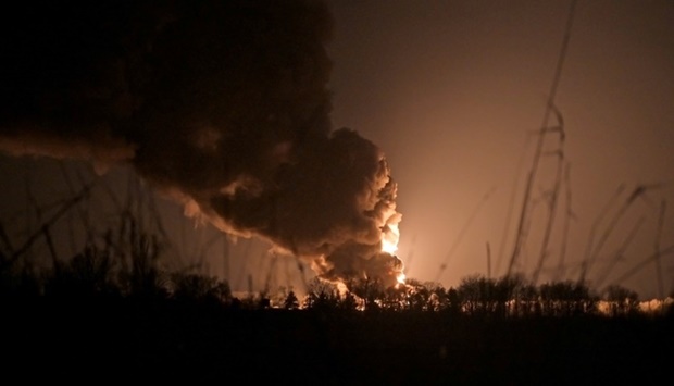 A view shows a burning oil depot reportedly hit by shelling near the military airbase Vasylkiv in the Kyiv region, Ukraine. REUTERS/Maksim Levin